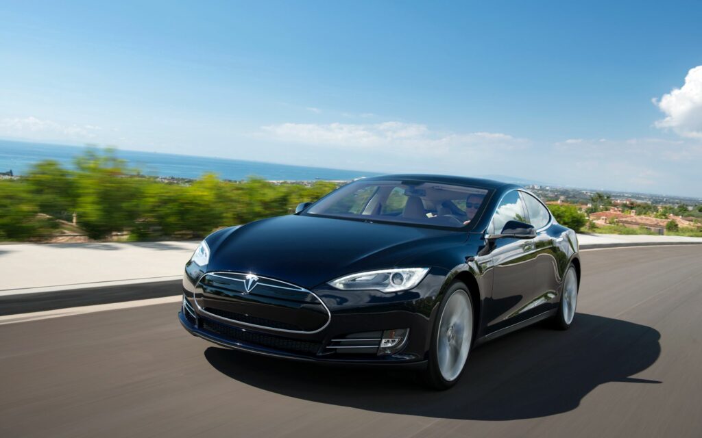 Scenic Tesla Model S Wallpaper: Sleek Electric Vehicle in Motion