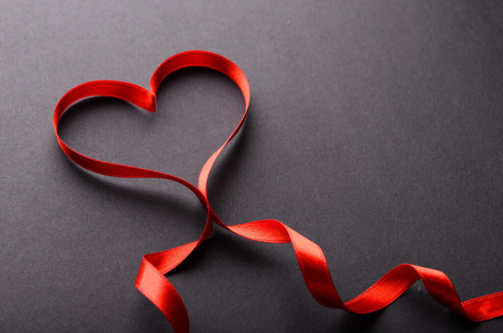 Sleek Valentine's Day Wallpaper: Red Ribbon Heart on Dark Background