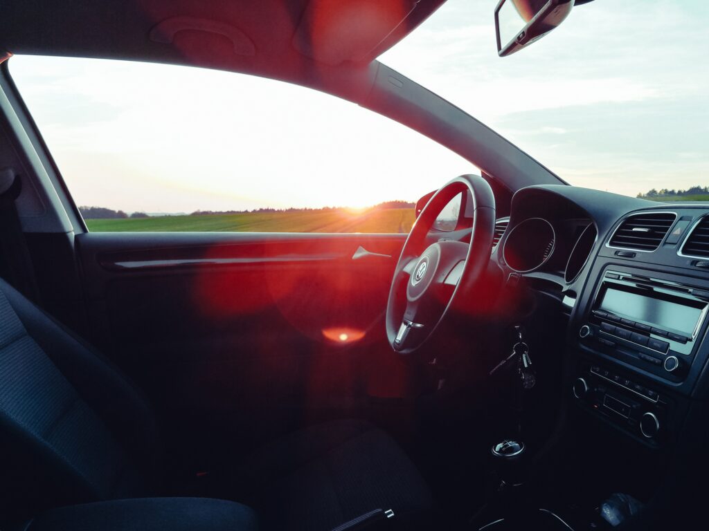 Sleek Volkswagen Interior Wallpaper: Dashboard & Wheel at Sunset