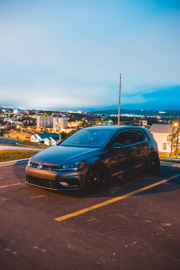 Sleek Volkswagen R Wallpaper with Scenic City Skyline Background
