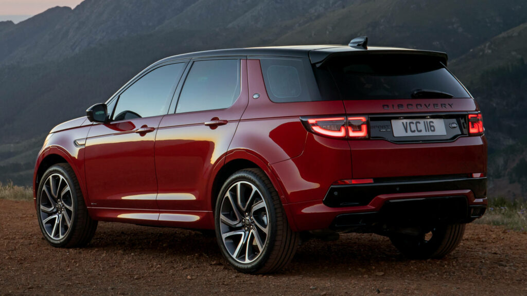 Stylish Red Land Rover Discovery Wallpaper in Stunning Mountainscape