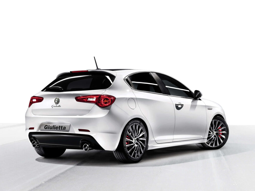 White Alfa Romeo Giulietta rear view on road with sporty design and stylish alloy wheels wallpaper