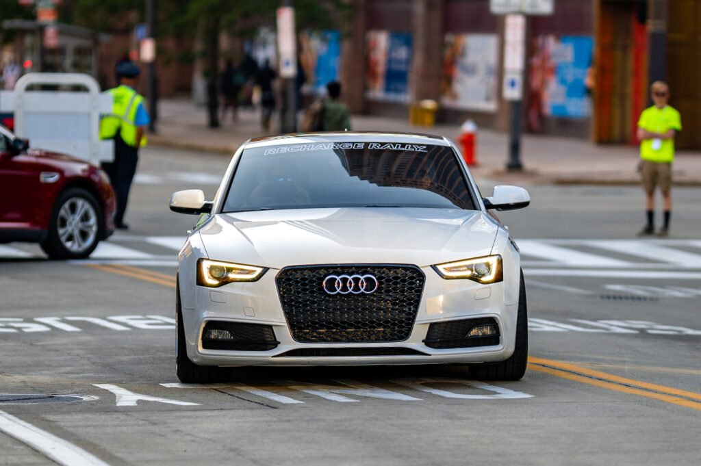 Sleek White Audi Front View in Dynamic Urban Road Setting Wallpaper