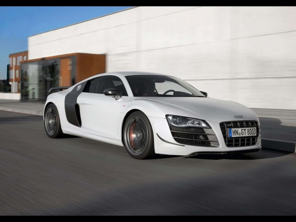 White Audi R8 52 speeding in cityscape with sleek dynamic design and sporty elegance wallpaper