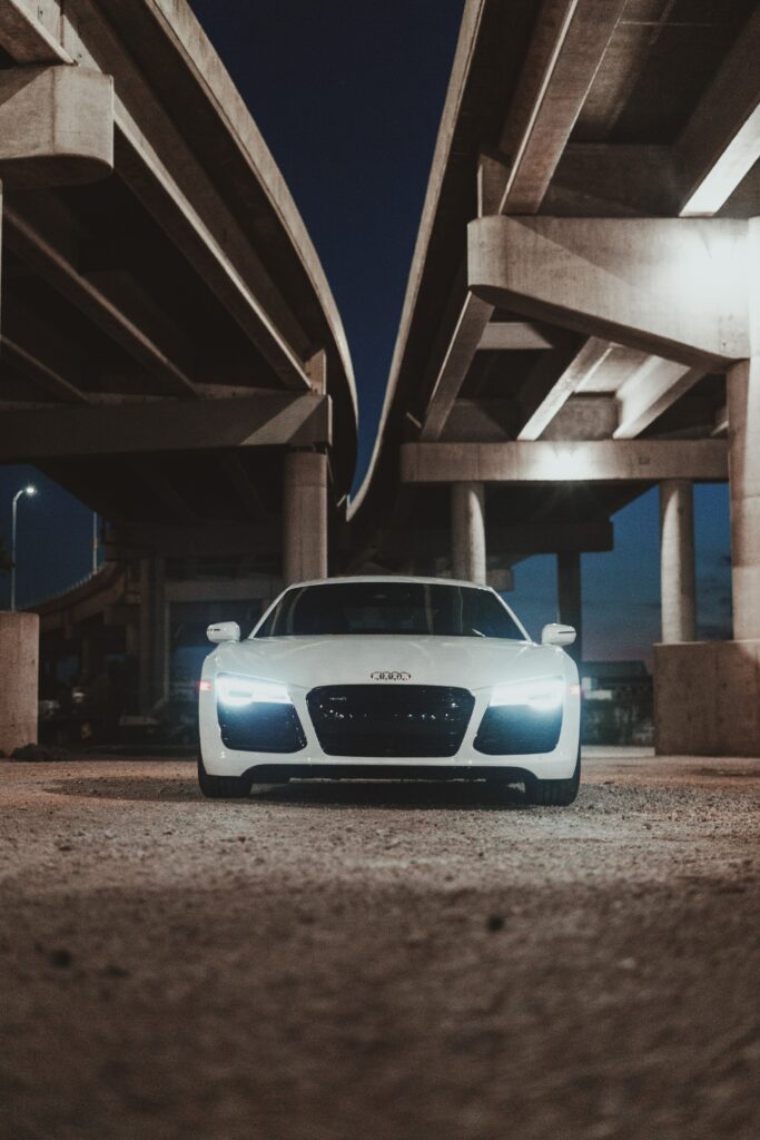 Sleek White Audi R8 Wallpaper: Dramatic Urban Overpass Design
