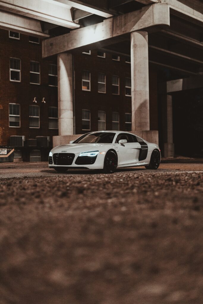Stunning Side View of White Audi R8 Against Urban Backdrop Wallpaper