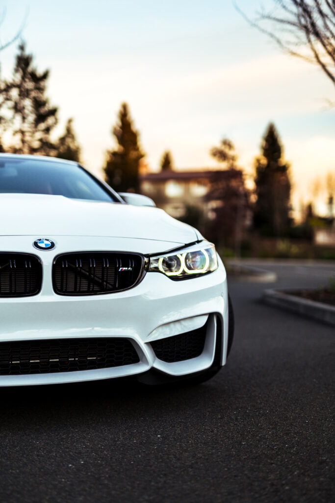 Elegant White BMW Front View Wallpaper in Outdoor Setting