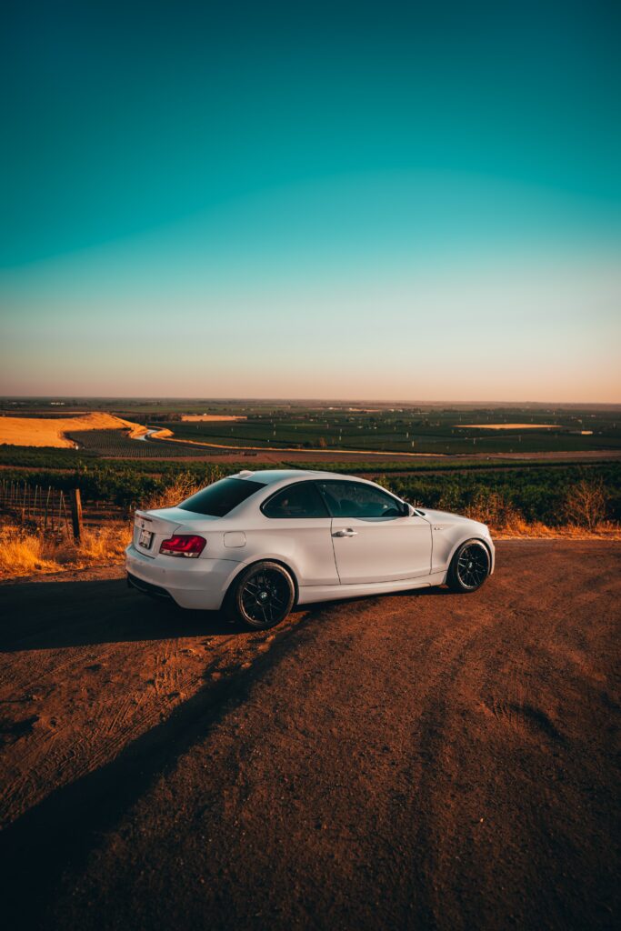 Sleek White BMW Side View in Serene Rural Landscape Wallpaper