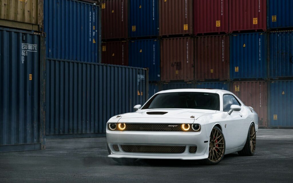 Bold White Dodge Challenger Against Industrial Shipping Containers Wallpaper