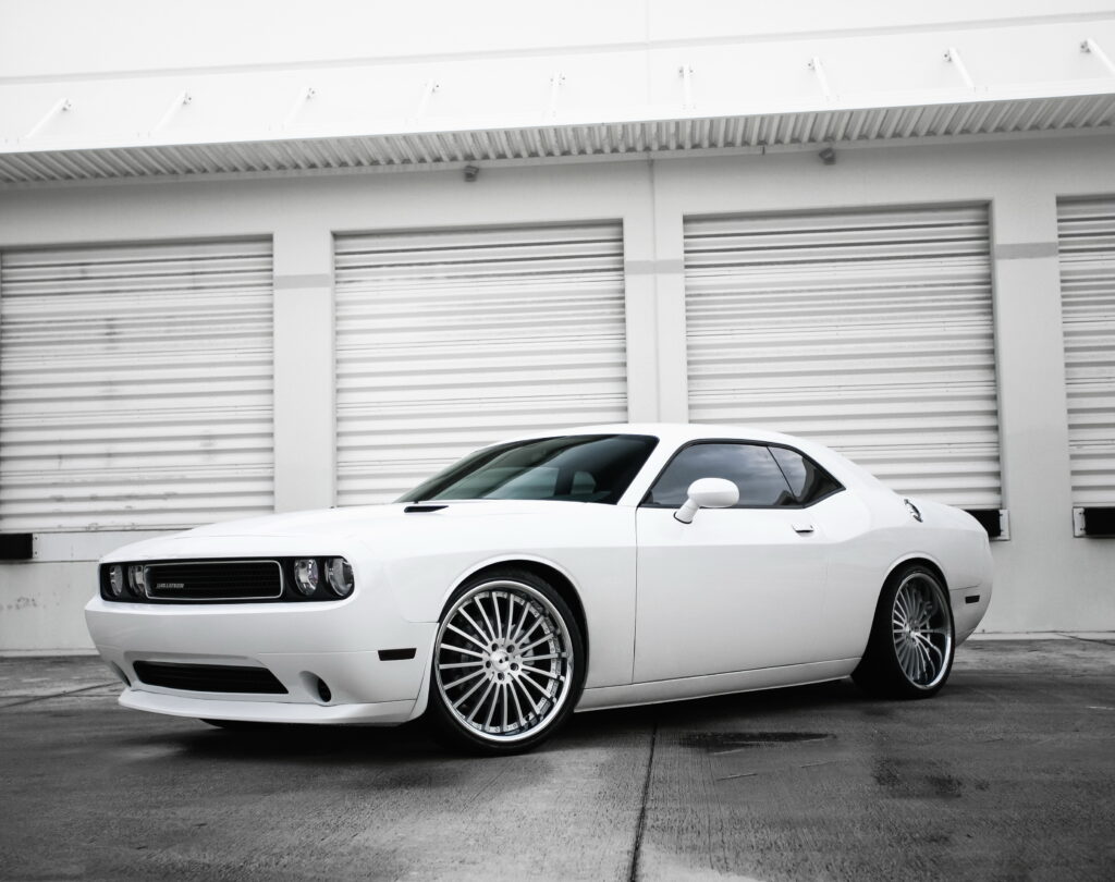 Stylish White Dodge Challenger Side View Wallpaper in Industrial Setting