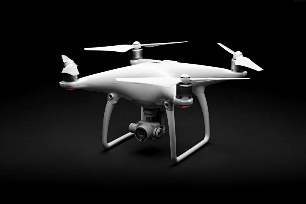 White sleek drone with high-resolution camera and streamlined propellers on black background Wallpaper
