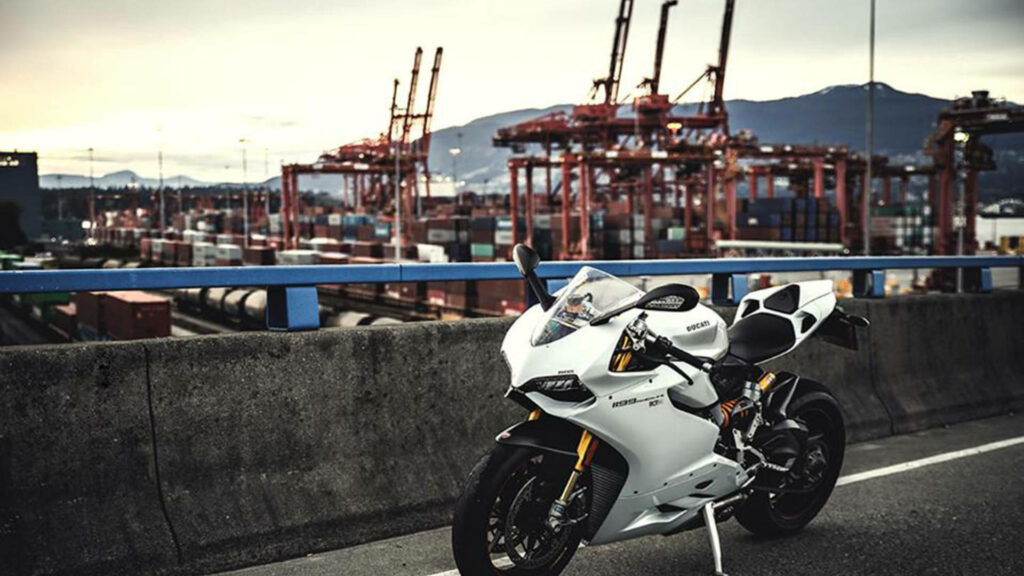 Stunning Ducati Wallpaper: Sleek Motorcycle at Dynamic Port Scene