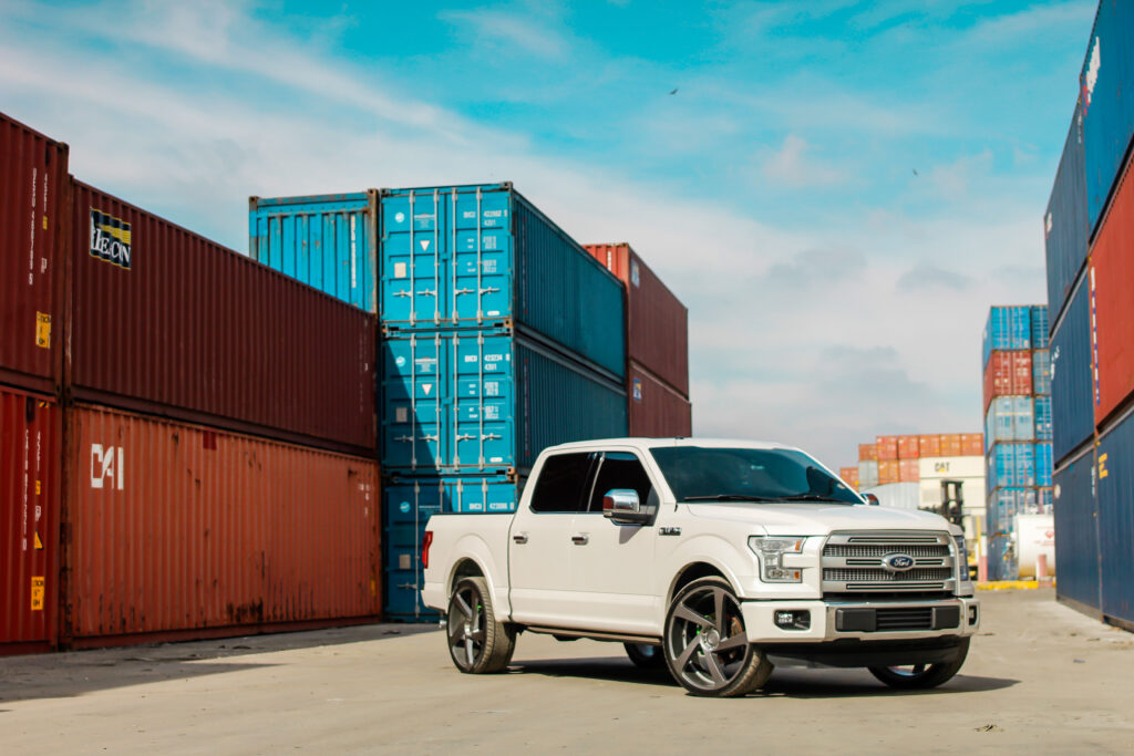 Sleek White Ford F-150: Stylish Front View with Colorful Background Wallpaper