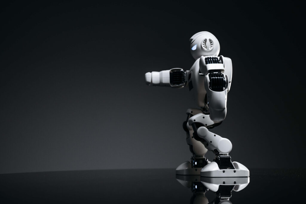 Sleek White Humanoid Robot on Dark Minimalist Background - Futuristic Design Wallpaper