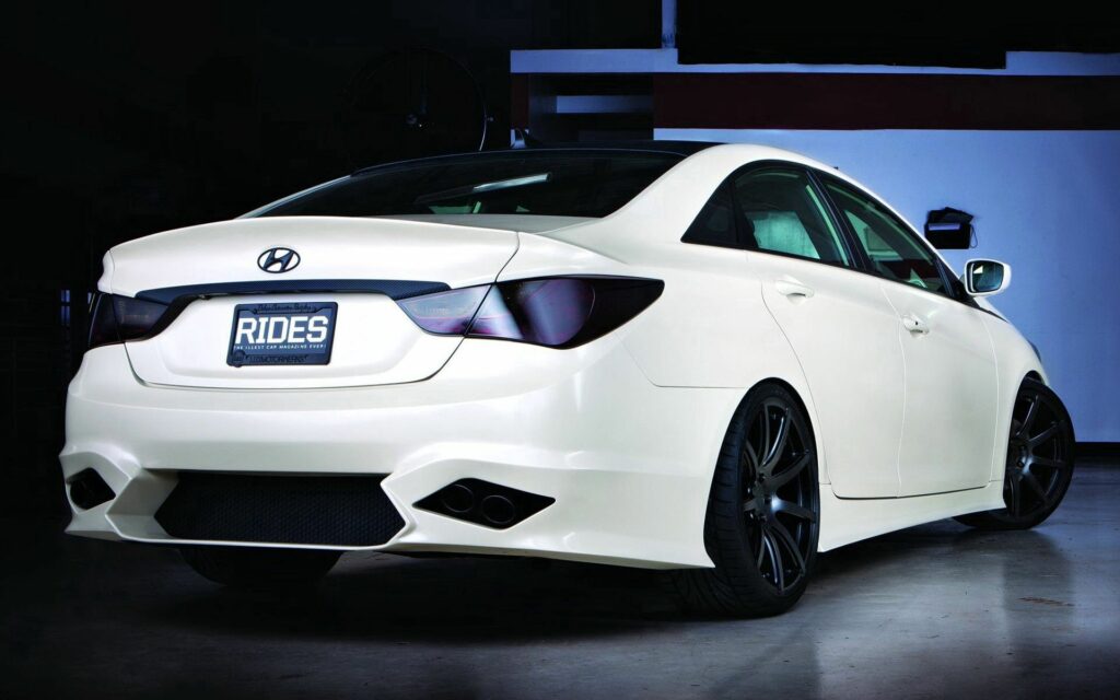 Sleek White Hyundai Sonata Rear View in Modern Garage Setting Wallpaper