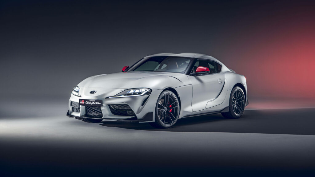 White JDM sports car with aerodynamic design on modern gradient wallpaper background