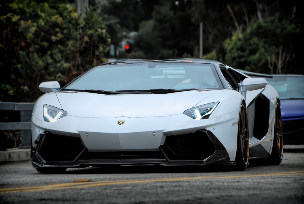 Stunning White Lamborghini: Front View Wallpaper with Blurred Background