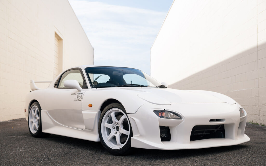 Sleek White Mazda RX-7 Wallpaper in Minimalist Urban Background