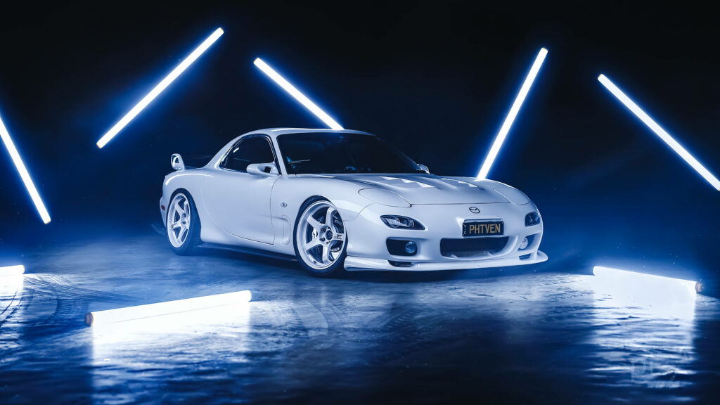 White Mazda RX7 with vibrant neon LED lights in a dark modern setting wallpaper background