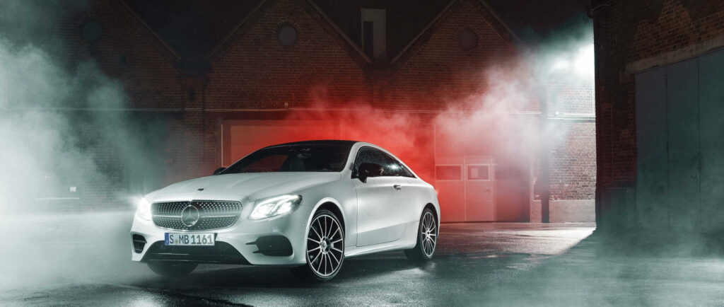 Sleek White Mercedes Benz Wallpaper with Dramatic Red Smoke Background