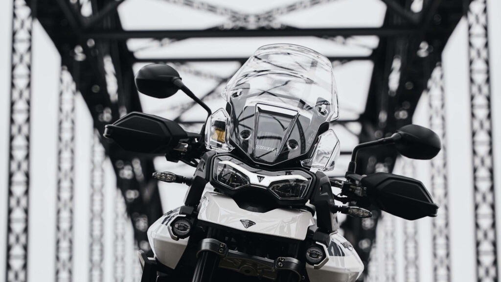 Sleek White Motorcycle on Metallic Bridge - Bold Design Wallpaper