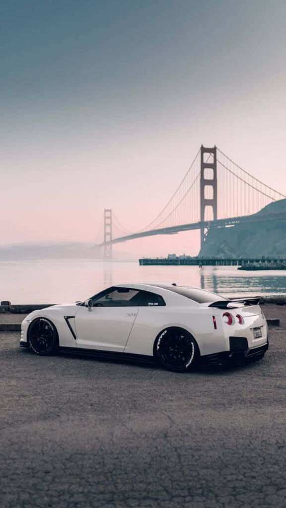 White Nissan R35 GTR parked by water with Golden Gate Bridge scenic background wallpaper