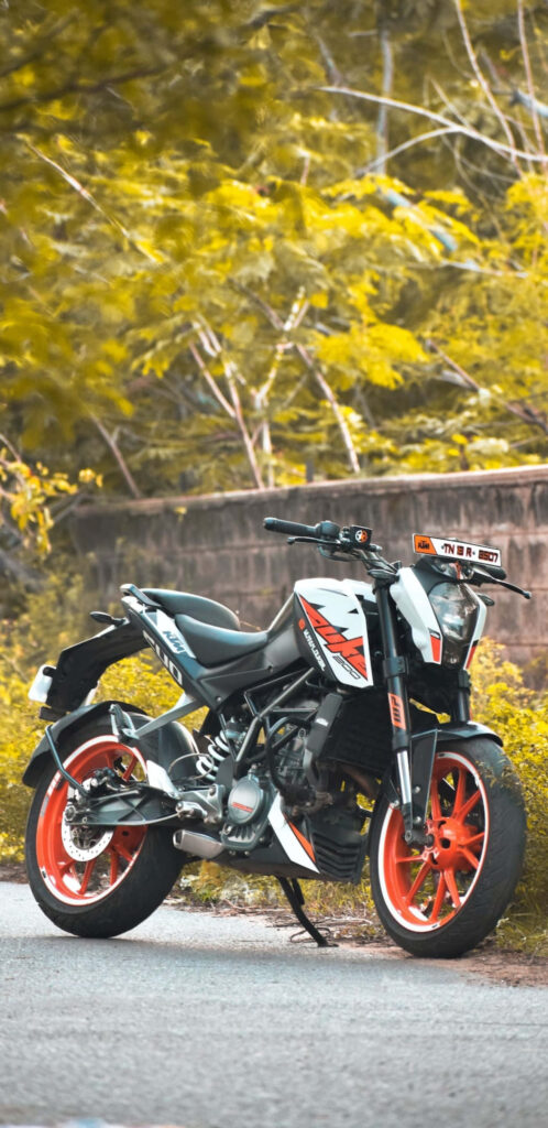 Sleek White & Orange Motorcycle in Lush Greenery - Dynamic Wallpaper