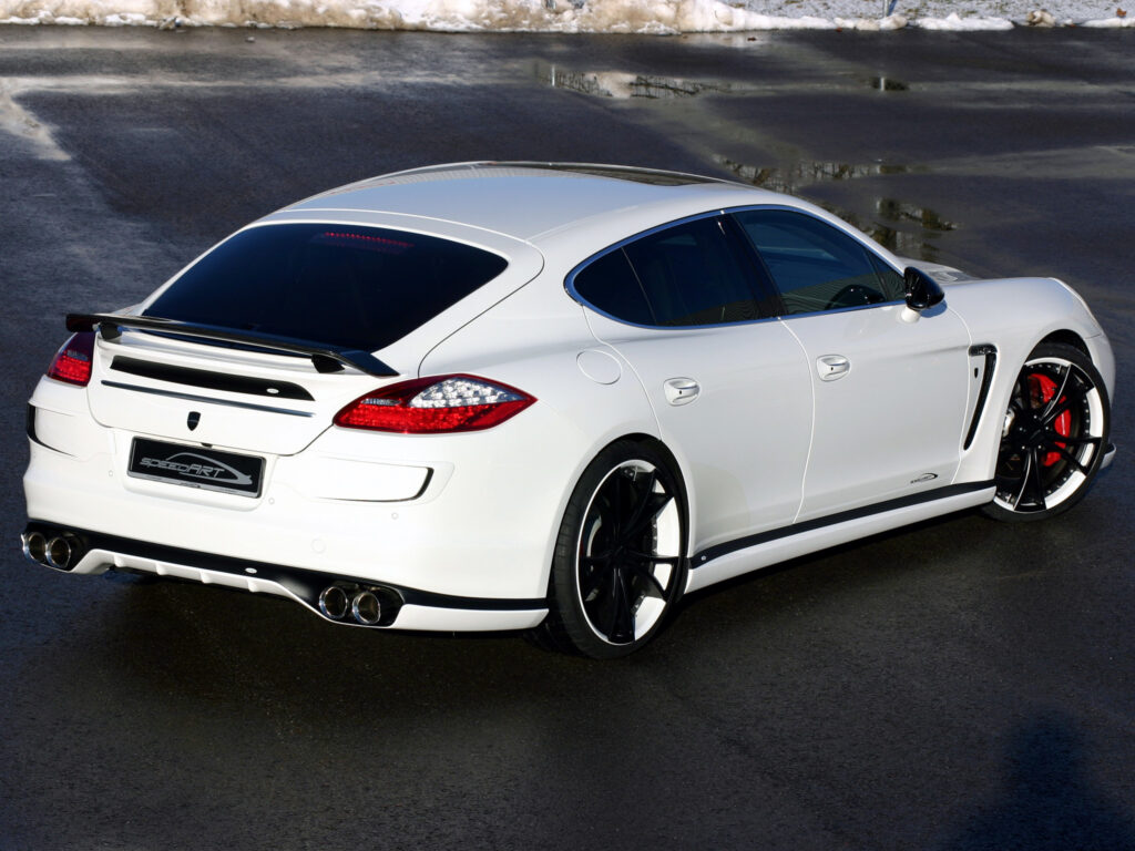 Sleek White Porsche Panamera: Elegant Rear View on Wet Pavement Wallpaper