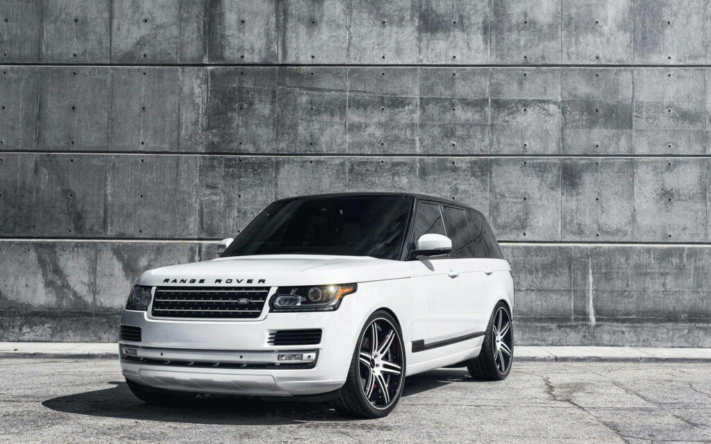 Premium White Range Rover 4K Wallpaper Against Industrial Wall
