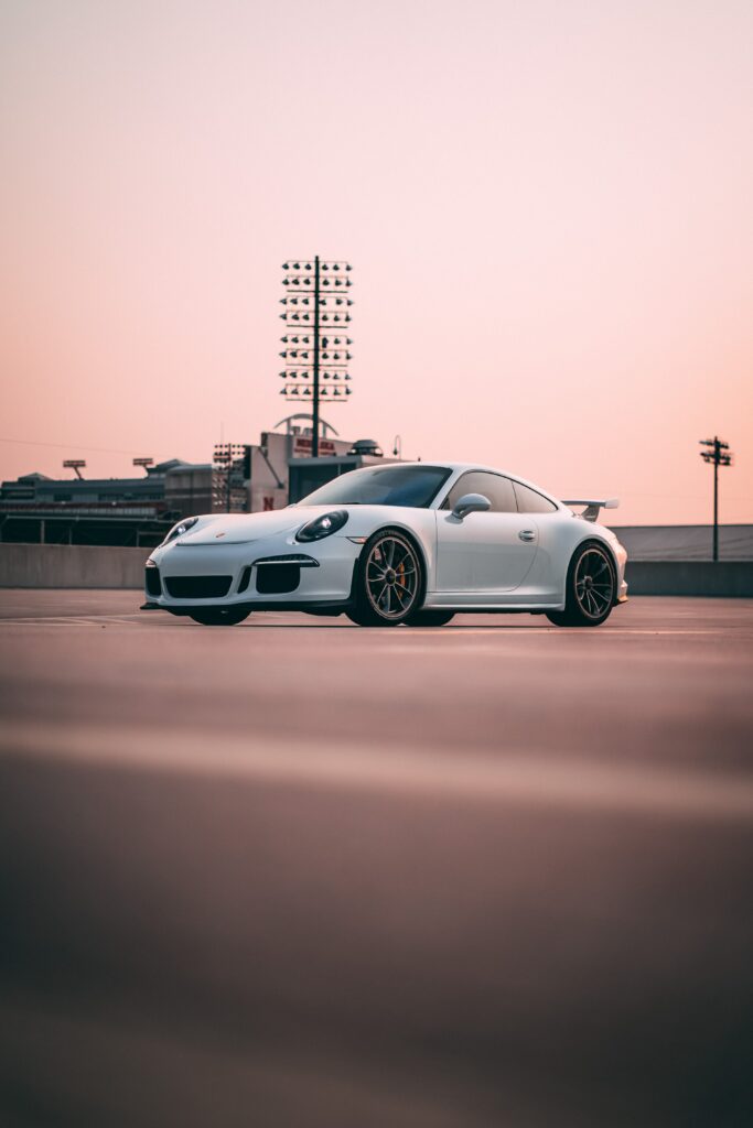 Sleek White Sports Car Side View Wallpaper with Warm-Toned Background
