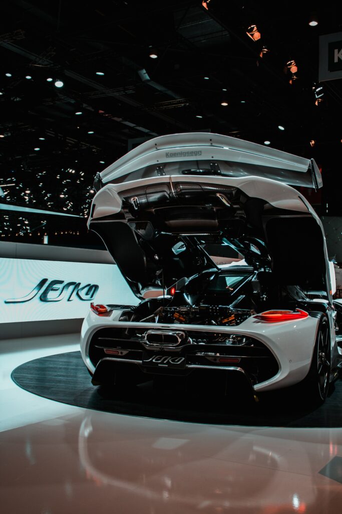 Stunning White Sports Car: Rear Engine Revealed Under Show Lights Wallpaper