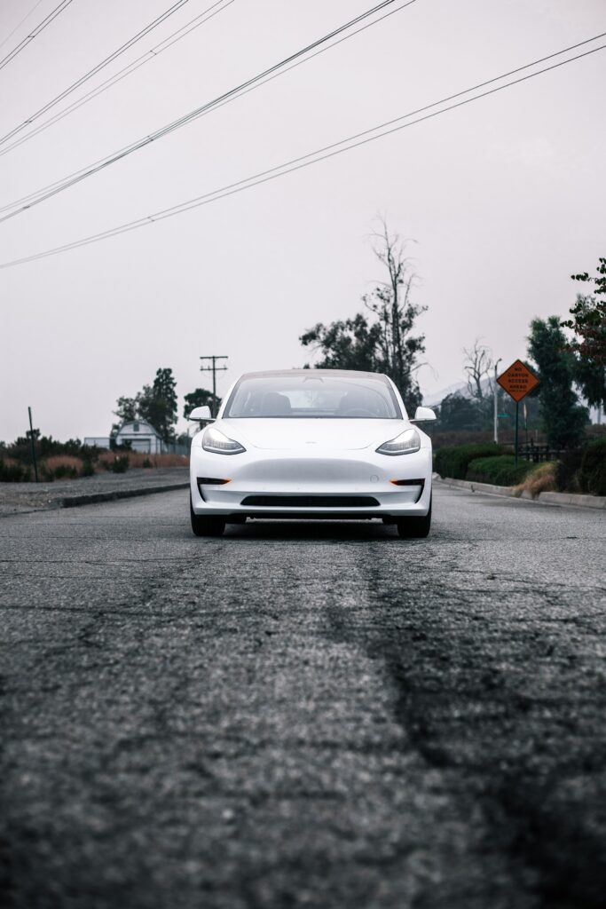 Futuristic White Tesla Sports Car Wallpaper | Suburban Street View