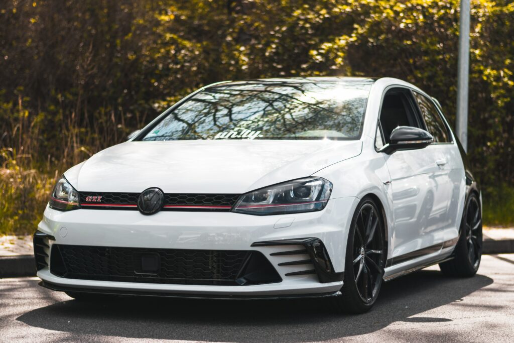 Sleek White Volkswagen GTI in Sporty Side View with Blurred Background Wallpaper