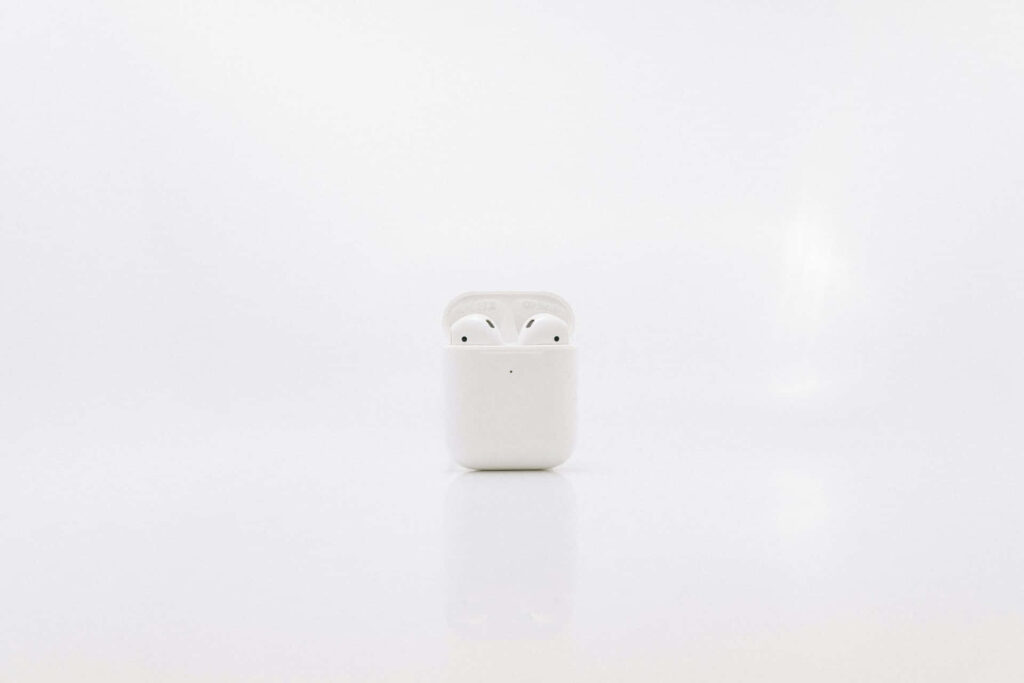 Sleek White Wireless Earbuds in Case - Minimalist Background Wallpaper