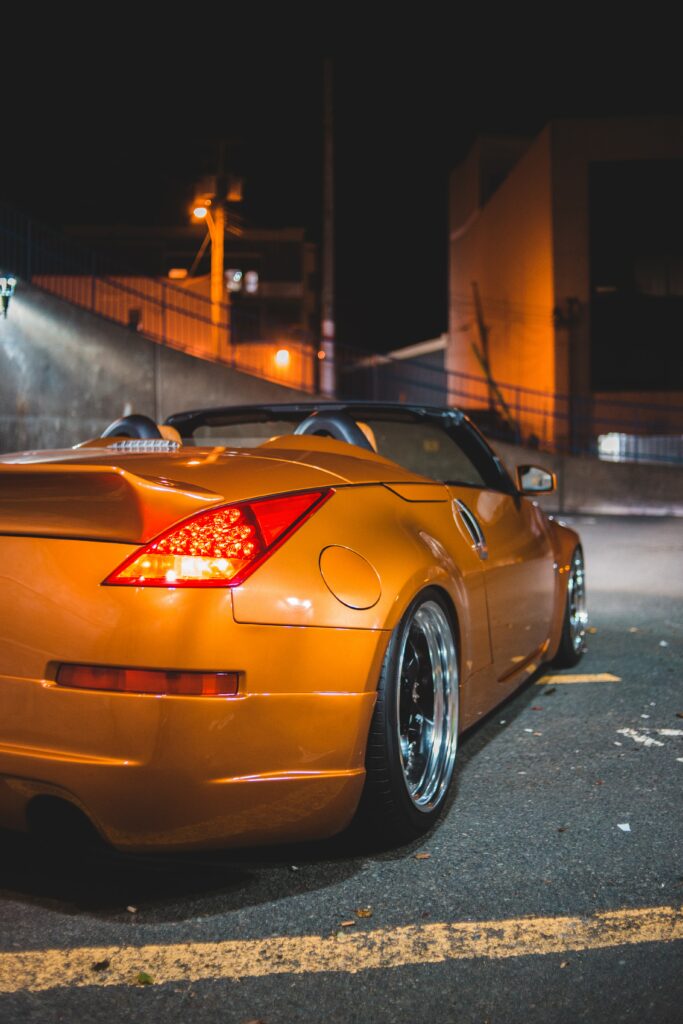Stylish Yellow Sports Car in Urban Night Background – Rear View Wallpaper