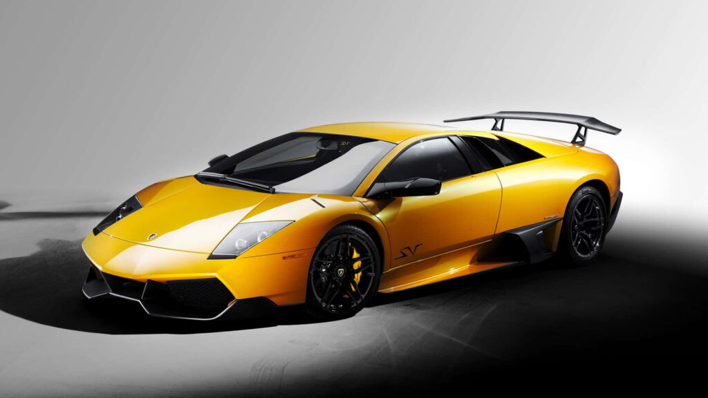 Sleek yellow sports car in dim room showcasing sharp lines aggressive design wallpaper background