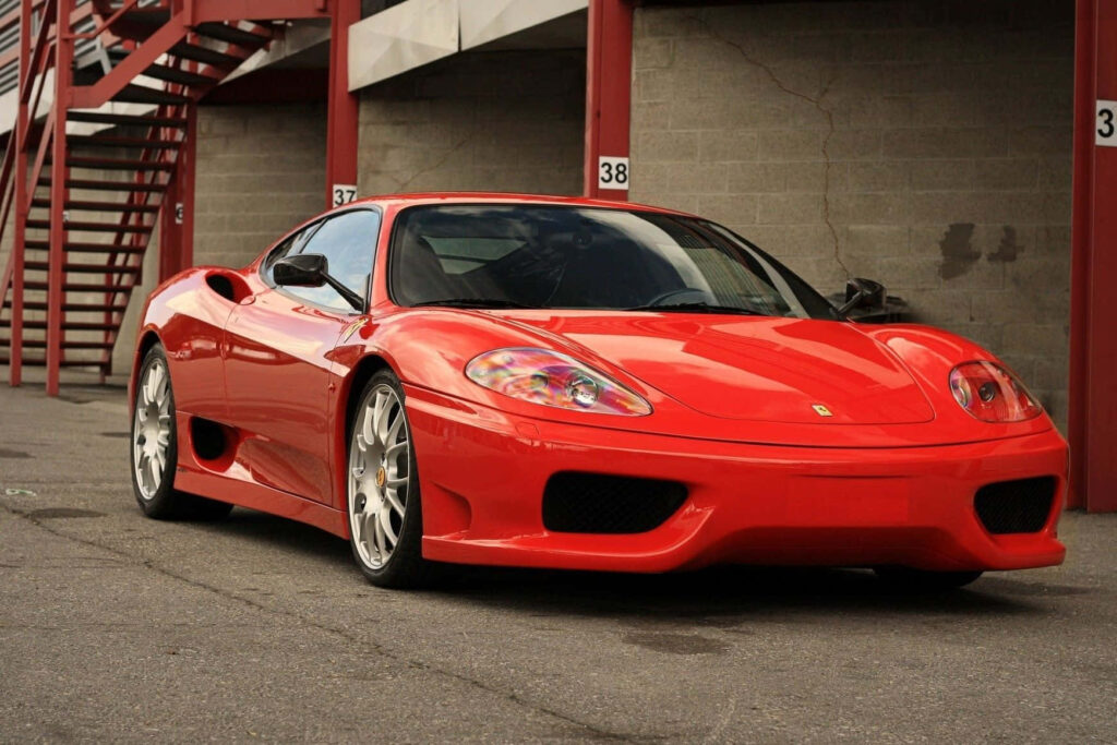 The Exquisite Power: A Captivating Red Ferrari 360 Modena Commands Attention on an Abandoned Stretch of Asphalt Wallpaper