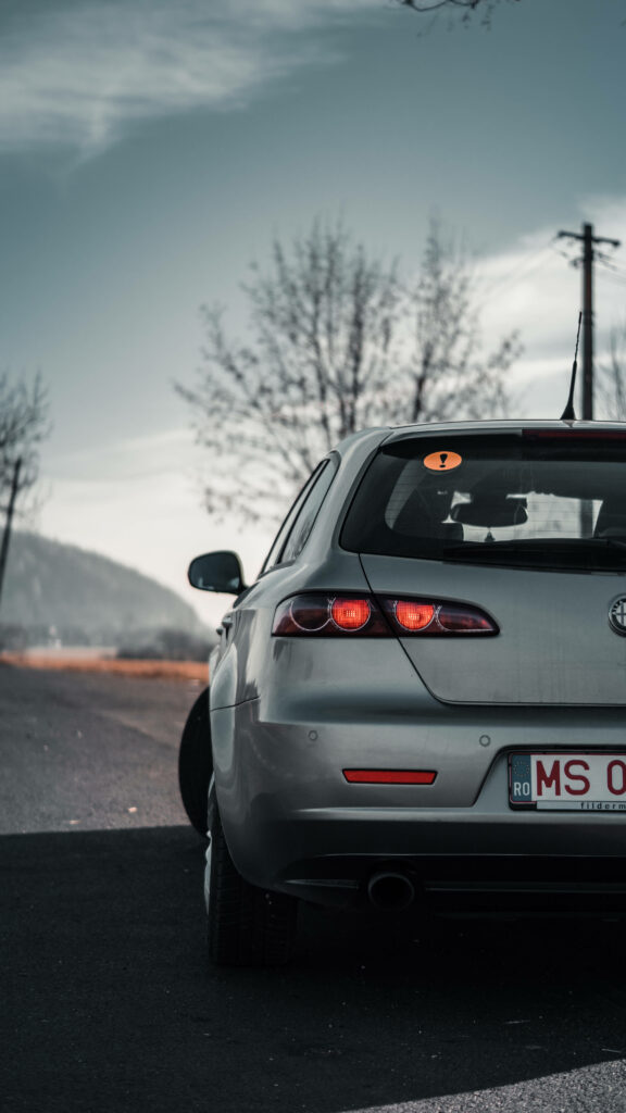 A Captivating Rear View: Alfa Romeo's Alluring Car Graces an iPhone Background Wallpaper