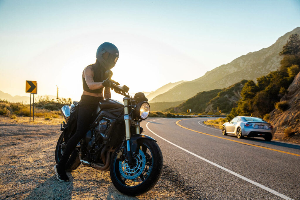 The Badass Biker: A Stylish Road Explorer with a Striking background Wallpaper