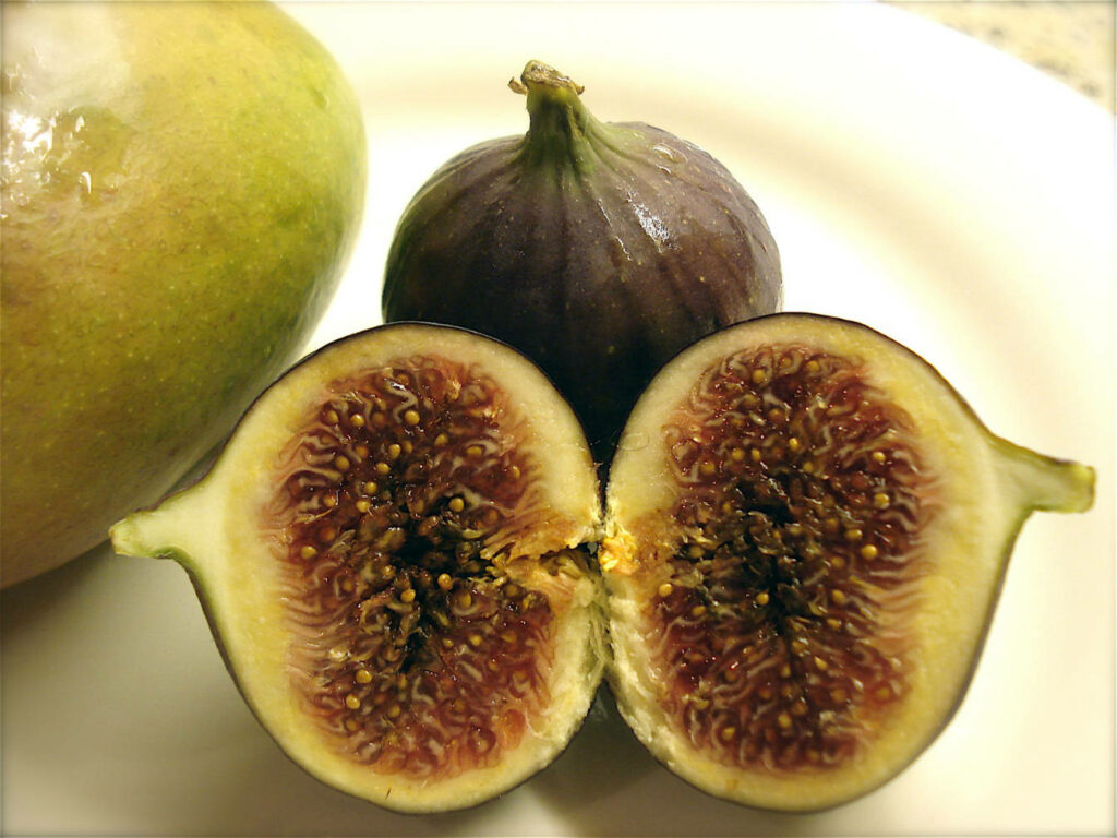 Close-Up of Sliced Fig: Textured Core & Fresh Fruits on Light Background Wallpaper