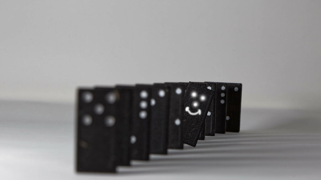 Playful Smiley Face Dominoes on Light Background Wallpaper