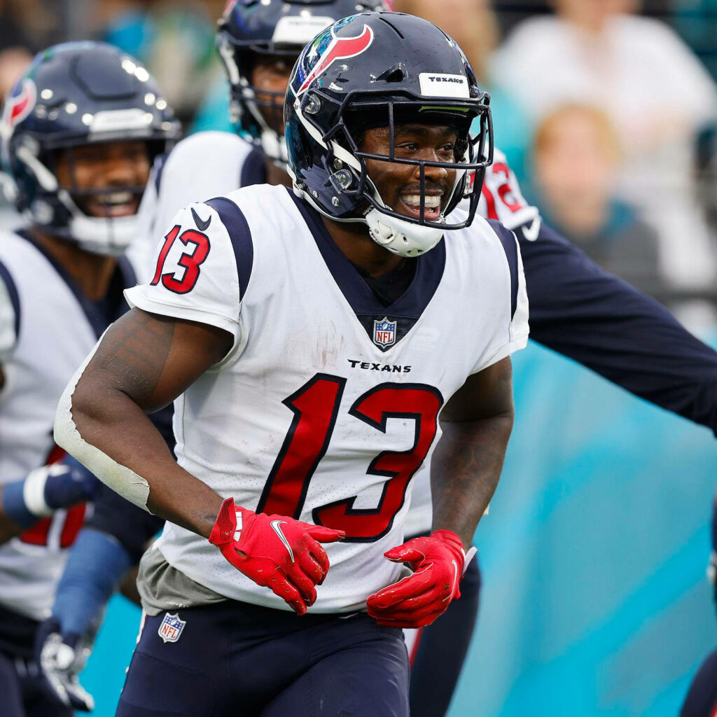 Brandin Cooks Houston Texans #13 in action on football field with vibrant team colors wallpaper