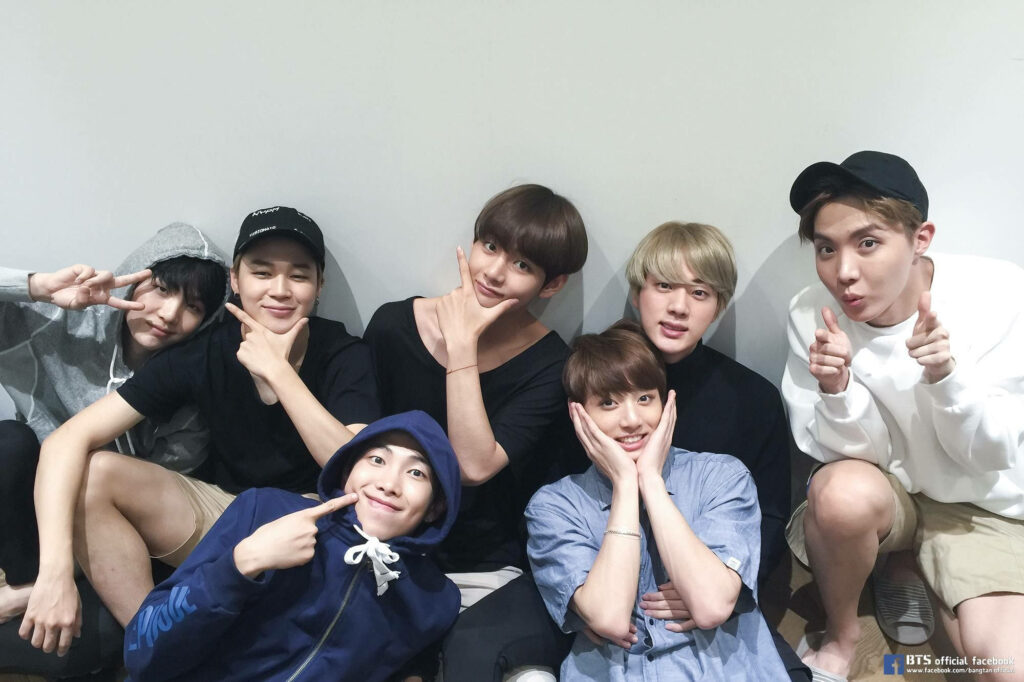 Beaming BTS: All-Smiles Members Wallpaper with Vibrant Background
