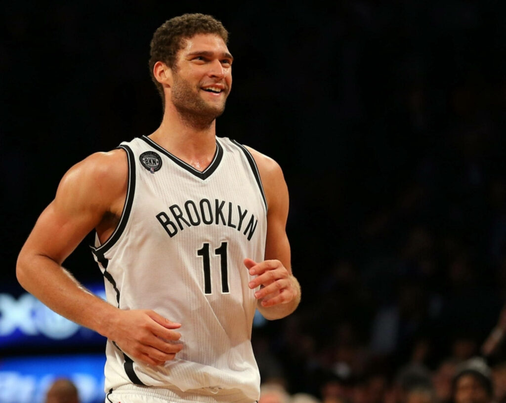 Smiling Brook Lopez in Brooklyn Nets black and white jersey number 11 dynamic basketball wallpaper