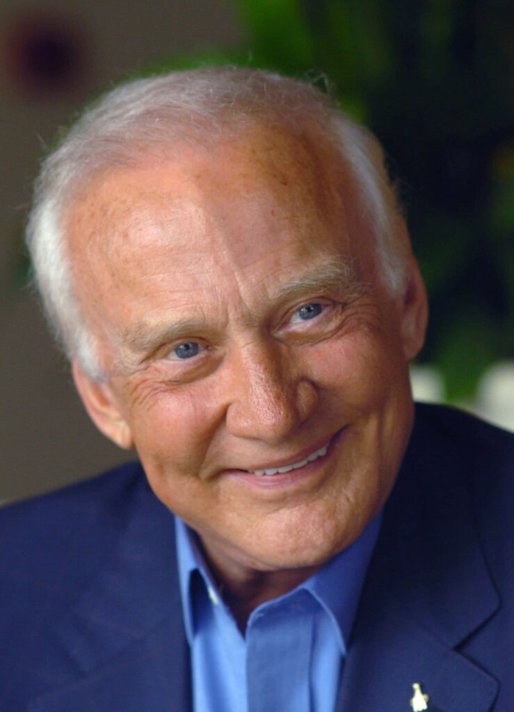 Smiling elderly Buzz Aldrin portrait warm light space explorer wallpaper background