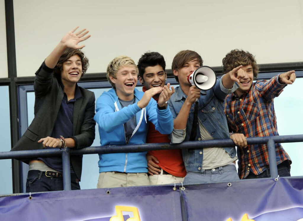 One Direction's Unbreakable Bond: United Smiles Amidst Devoted Fanbase Wallpaper