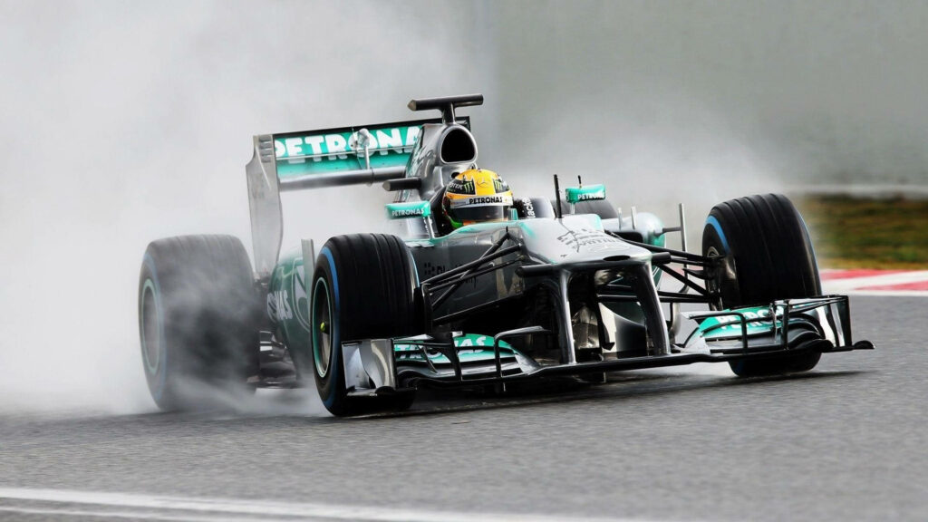 Racing Dynamo: Lewis Hamilton's Smoking Mercedes F1 Speedster Takes the Road by Storm Wallpaper