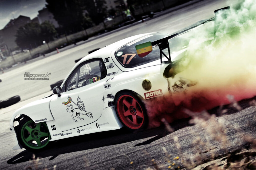 Revved Up Chaos: Mazda Rx-7 Drift Car Sets the Scene Ablaze with Vibrant Smoke Trails and Bold Mag Wheels Wallpaper
