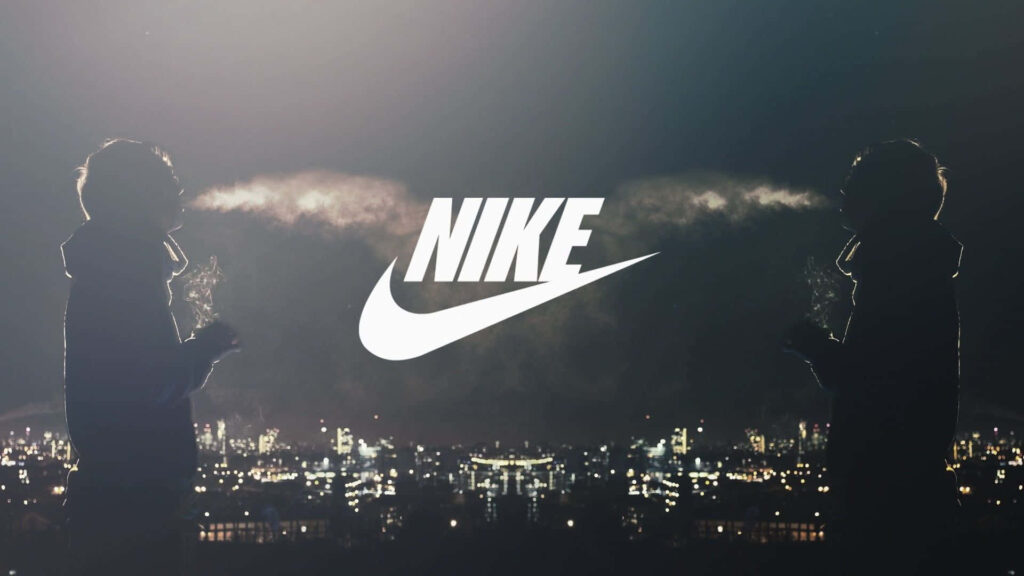 Nike logo with glowing city skyline and two silhouettes exhaling smoke urban night wallpaper