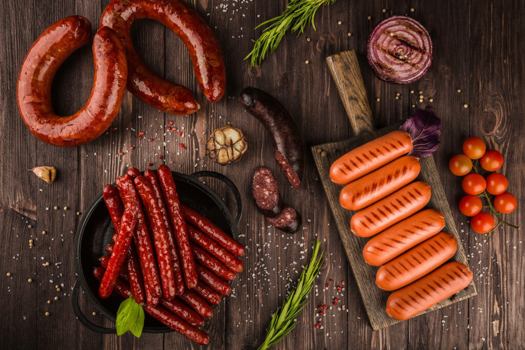 Rustic Grilled Sausages & Fresh Ingredients Wallpaper - Smoky Delight